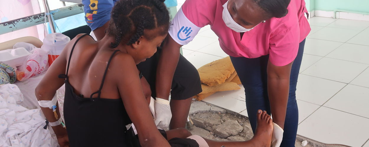 LES CAYES, HAITI - AUGUST 15: A boy is tended to outside Les Cayes General Hospital after a 7.2-magnitude earthquake on August 15, 2021 in Les Cayes, Haiti.