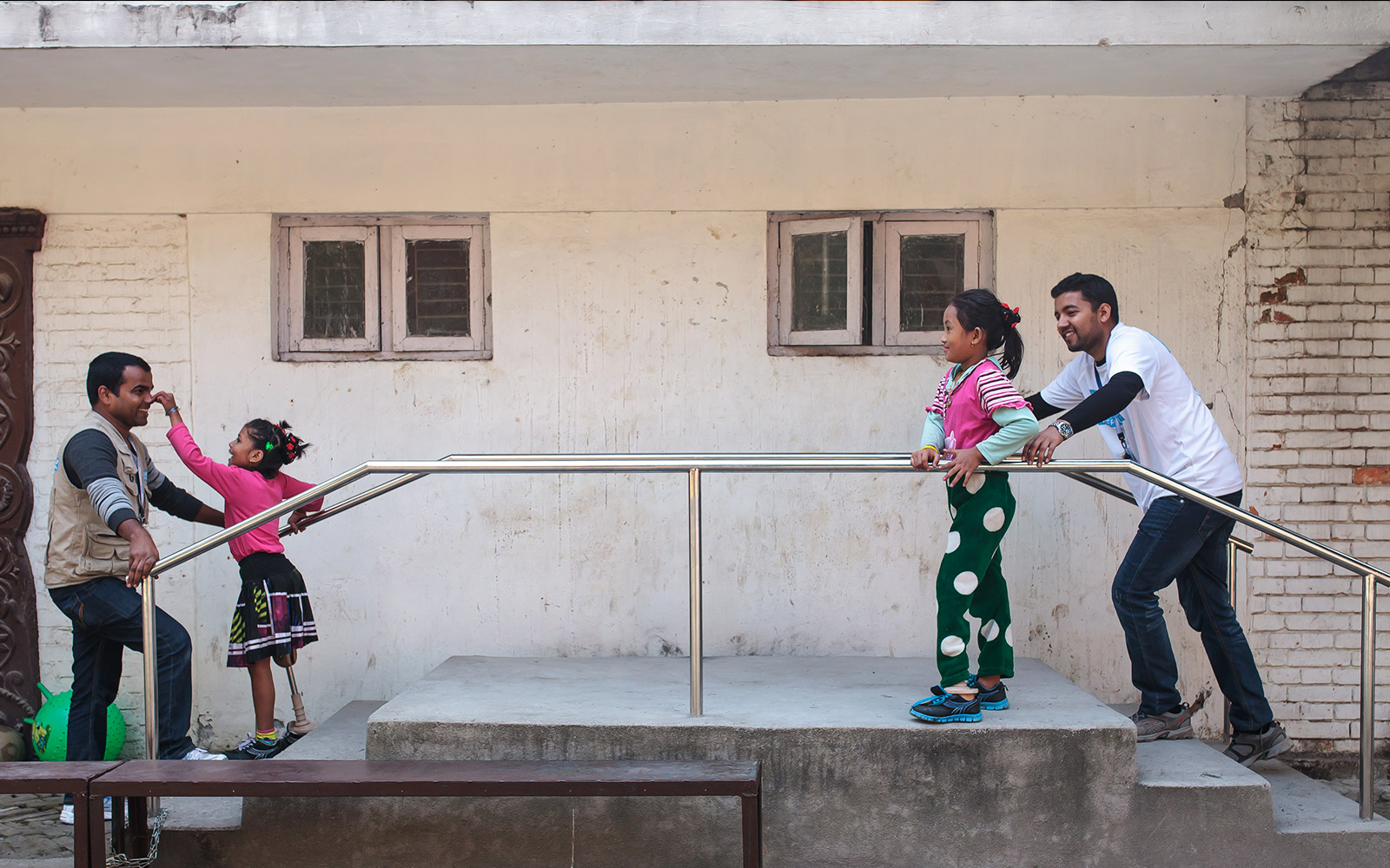 Nepal, Nirmala (left), with Jay from HI and Khendo (right) with Sudan from HI. Girls were both victims of the 2015 earthquake, fitted with a prosthesis, they follow rehabilitation sessions.