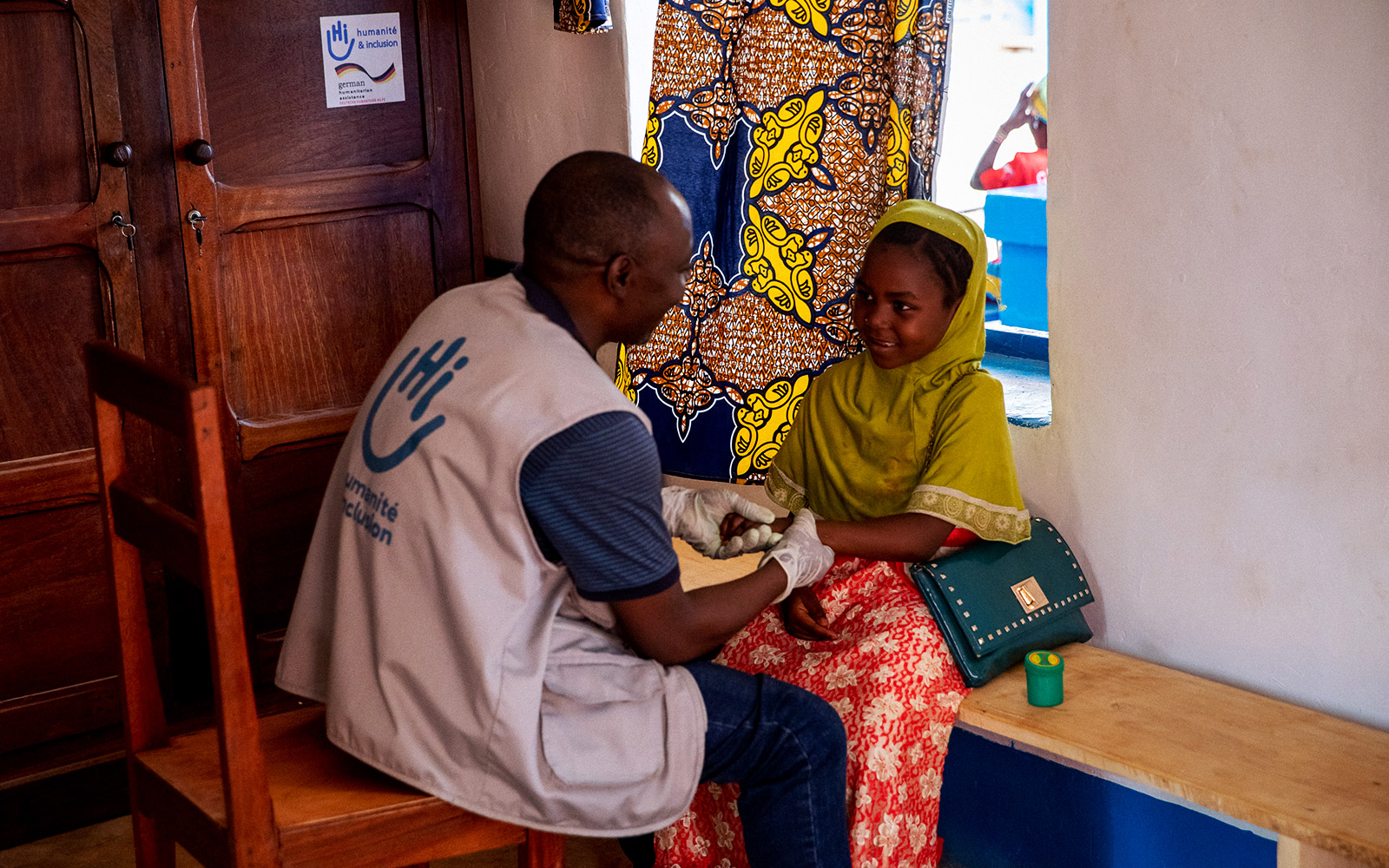 Central African Republic, Bambari, Waïda Sadia, is receiving rehabilitation care from a physiotherapist of HI.