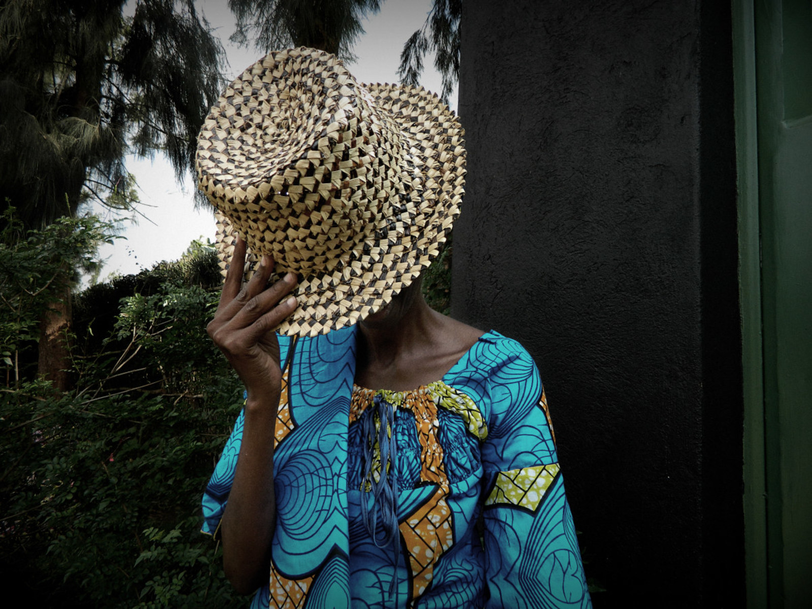 Woman hiding her face in a hat