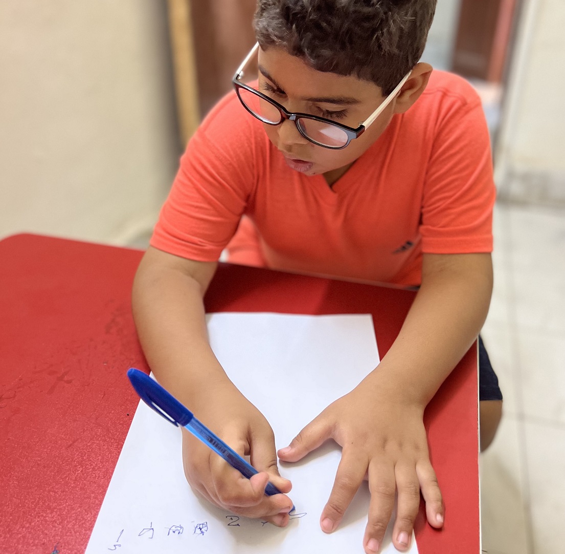 Sherif s'exerce à l'écriture.