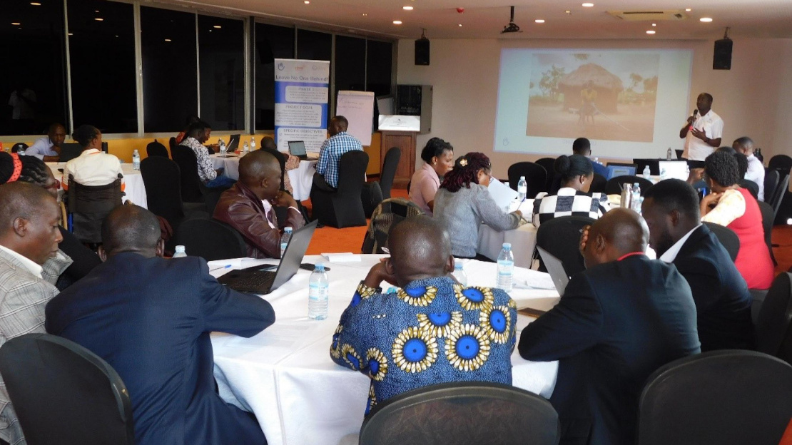 People gathered at a workshop in Uganda; }}