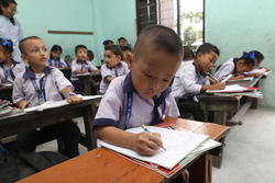Prabin studying in class, Nepal. © A.Thapa / HI