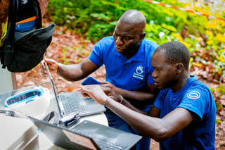 Abdourahmane Ba, head of operations, and Idrissa Manga, deminer and community liaison officer, preparing to destroy the rocket head. © A. Faye / HI