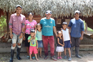 Walter’s family earns a living raising chickens and fish. © M. Campos / HI