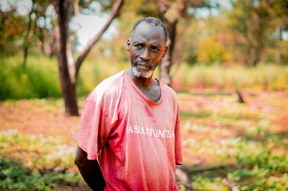 Moustapha watches over his field to make sure the monkeys don't steal his watermelons. © A. Faye / HI