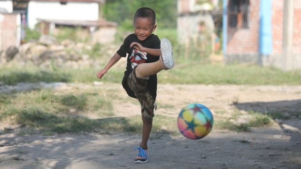 Prabin, 6, plays football.; }}