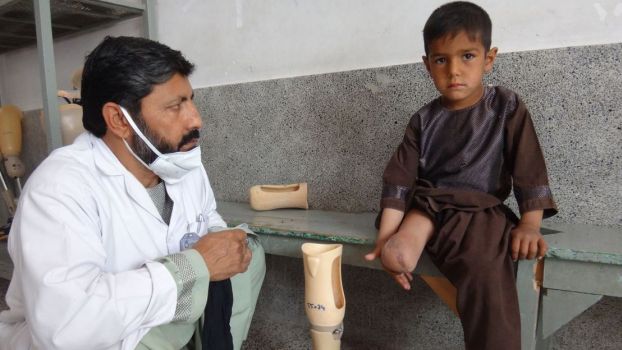 Enayatullah during a rehabilitation session with his physiotherapist. ; }}