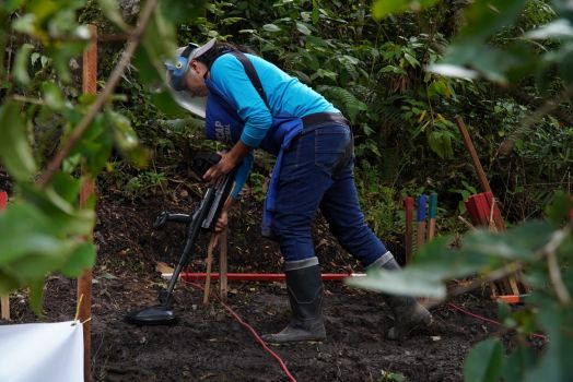 A deminer working in the Chaparral area, Colombia, where teams have to cope with regular flooding, rockslides and landslides.; }}