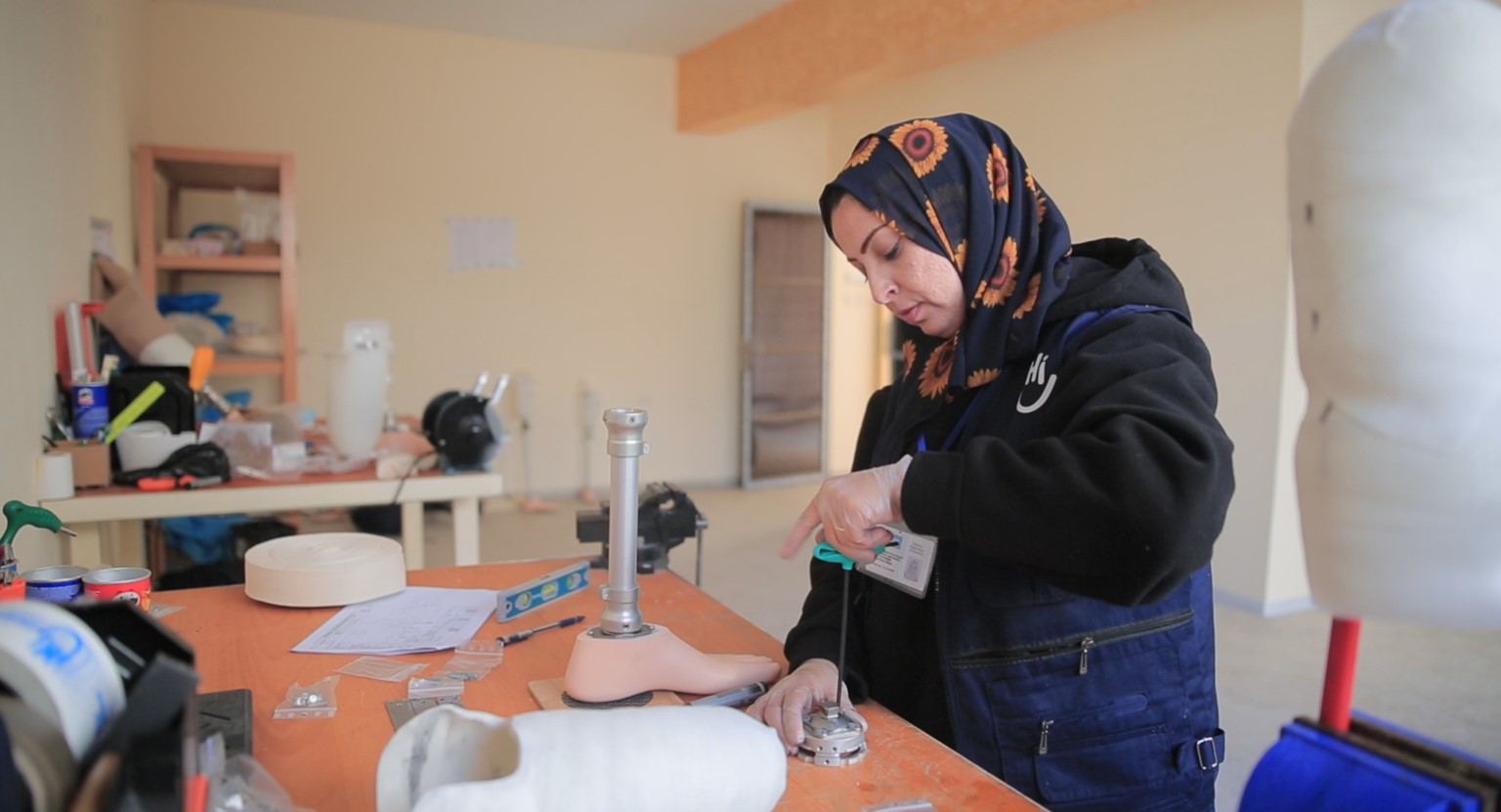 Heba au centre en train de fabriquer une prothèse; }}
