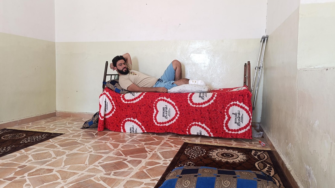 Osama at home after his amputation; }}