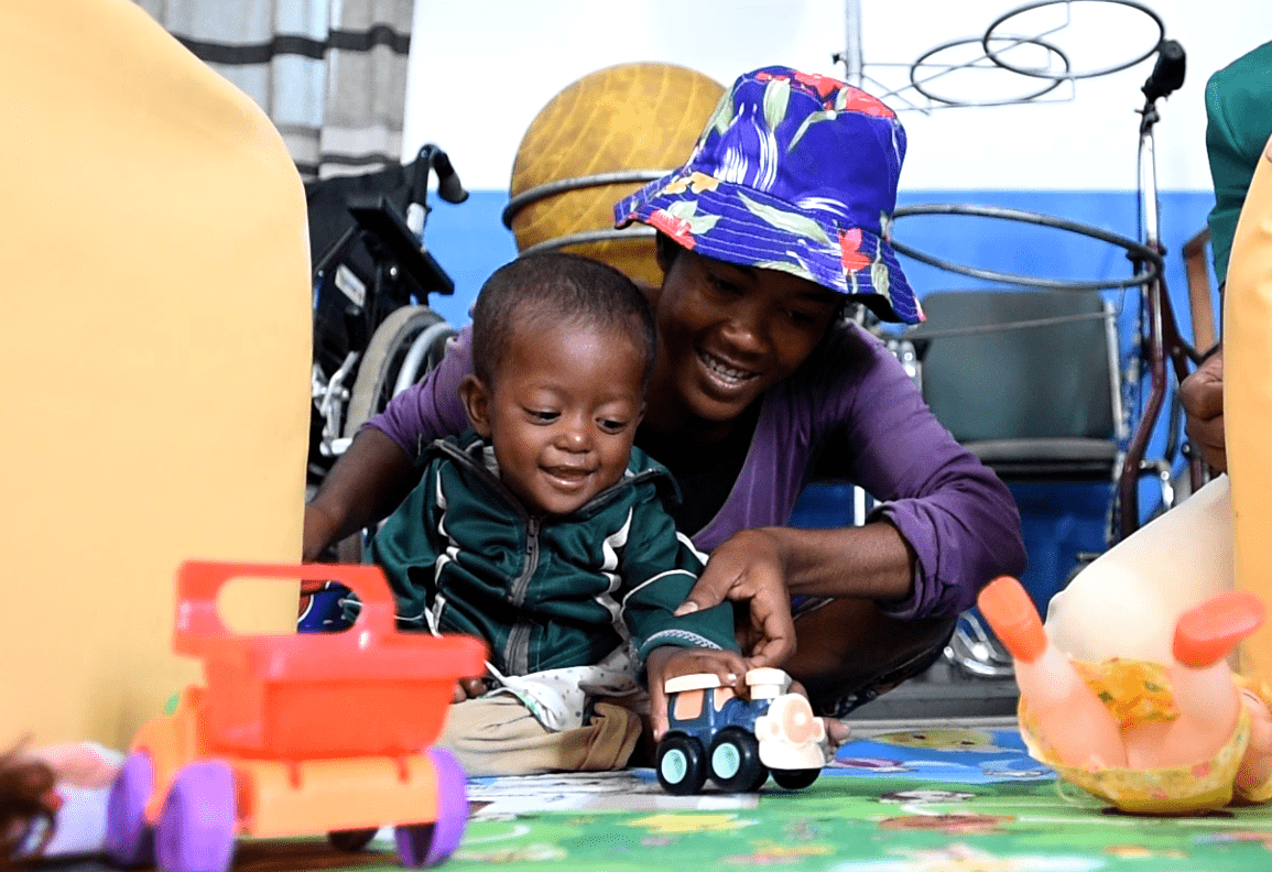 Sosiany and Naliny play with a toy car during stimulation therapy.