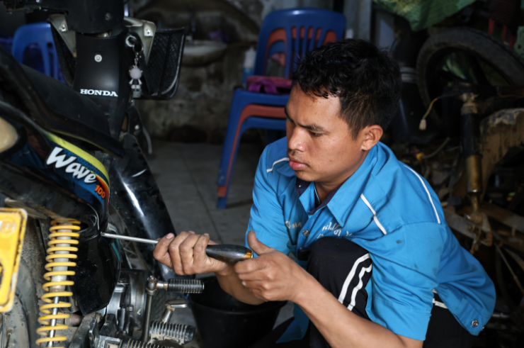 Mr. Dee working on a motorcycle