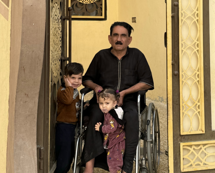 Hmoud, sitting in a wheelchair, in the patio of his house.