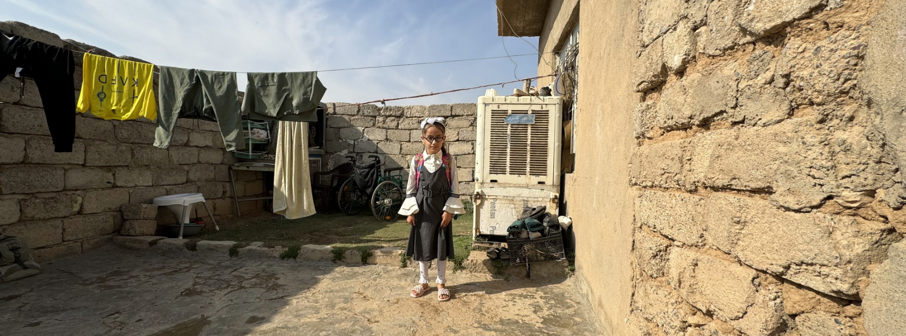 A girl standing in a courtyard.