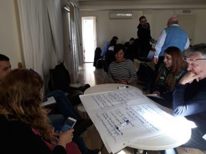 group of people discussing and working around a table